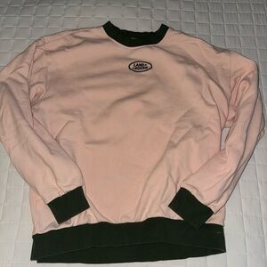 Pink and dark green Land Rover pull over